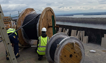 Workers are laying the cable.